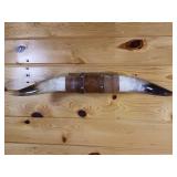25 inch bull horn mounted on wood wall hanger