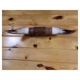 25 inch bull horn mounted on wood wall hanger