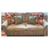 SR - Grey Upholstered Couch with Floral and Green Throw Pillows