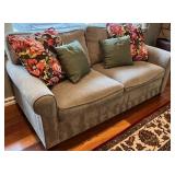 SR - Grey Upholstered Couch with Floral and Green Throw Pillows