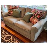 SR - Grey Upholstered Couch with Floral and Green Throw Pillows