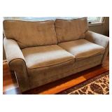 SR - Grey Upholstered Couch with Floral and Green Throw Pillows