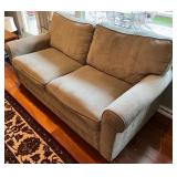 SR - Grey Upholstered Couch with Floral and Green Throw Pillows