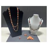 Collection of Vintage Coral Jewelry Including Necklaces, Rings, and Brooches