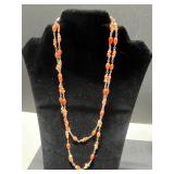 Collection of Vintage Coral Jewelry Including Necklaces, Rings, and Brooches