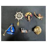 Collection of Costume Brooches Including Cat, Lion, Bird, Sailboat, Nautical Wheel, and Abstract Designs