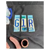 Mixed Lot of Vintage License Plates, Stone Carvings, and Miscellaneous Items in Storage Bins