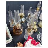 Antique Lot with Oil Lamps, Textiles, Suitcase, and Encyclopedia