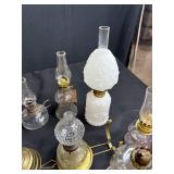 Antique Lot with Oil Lamps, Textiles, Suitcase, and Encyclopedia