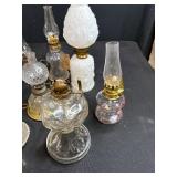 Antique Lot with Oil Lamps, Textiles, Suitcase, and Encyclopedia