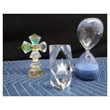 Crystal cross, Temples glass, and a large hourglass