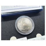 Five Coins: 1958 and 1959 Proof Jefferson Nickels; 1999 Proof Susan B. Anthony Dollar in U. S. Mint Package with COA; Two 1986-D Uncirculated Half Dollars