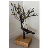 LL  - Metal Sculpture of Child on Swing Under Tree