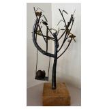 LL  - Metal Sculpture of Child on Swing Under Tree
