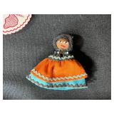 Collection of Vintage Curiosities Including Pottery Canteen, Figurines, Coasters, and Decorative Items