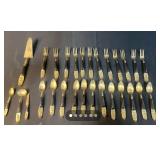 Siam 24-Piece Black and Brass Flatware Set with Embossed Handles