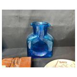 Eclectic Decorative Collection with Blue Glass Bottles, Plates, Wood Dish, and Longaberger Basket