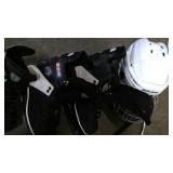 Tote with two pairs of hockey skates, 2 pairs of figure skates, and hockey helmet
