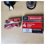 Automotive Parts Collection including BrakeBest Brake Shoes, Motorcraft Spark Plugs (SP-486), and NAPA Thermostat, Halogen headlamp (type HB1 9004).