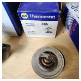 Automotive Parts Collection including BrakeBest Brake Shoes, Motorcraft Spark Plugs (SP-486), and NAPA Thermostat, Halogen headlamp (type HB1 9004).