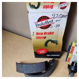 Automotive Parts Collection including BrakeBest Brake Shoes, Motorcraft Spark Plugs (SP-486), and NAPA Thermostat, Halogen headlamp (type HB1 9004).