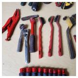 Assorted hand tools including Craftsman ratchet, wire strippers, utility knives, brushes, and sockets