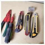 Assorted hand tools including Craftsman ratchet, wire strippers, utility knives, brushes, and sockets