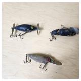 Vintage fishing lures with treble hooks including Jitterbug