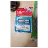 Assorted Automotive Parts Lot including Dorman Sending Unit Retainers, Autolite Spark Plugs, and Anti-Theft Door Lock Knobs