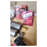 Assorted Automotive Parts Lot including Dorman Sending Unit Retainers, Autolite Spark Plugs, and Anti-Theft Door Lock Knobs