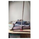 Assorted Construction and Plumbing Supplies including Squeegee, Fuel Tank Strap, Heating Tape, and Insulation Rolls