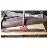 Assorted Construction and Plumbing Supplies including Squeegee, Fuel Tank Strap, Heating Tape, and Insulation Rolls