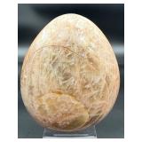 A graceful Peach Moonstone freeform, glowing with soft, warm hues of apricot and cream and flashes in the sunlight.