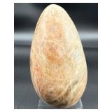 A graceful Peach Moonstone freeform, glowing with soft, warm hues of apricot and cream and flashes in the sunlight.