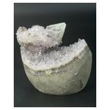 A stunning Amethyst crystal perched on its natural matrix, featuring delicate Calcite inclusions that add depth and character.