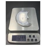 A luminous Botswana Agate druzy carved into a moon shape, showcasing delicate bands of soft gray, caramel, and cream. The sparkling druzy surface catches the light, in a custom metal stand.