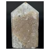 A delicate druzy Golden Healer quartz tower sparkling with a natural crust of tiny crystals atop warm golden tones. Slender and radiant, it amplifies healing, light.