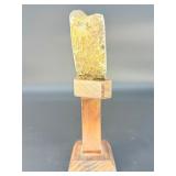 A mesmerizing deep amethyst portal, showcasing rich violet crystals that form a natural, glowing window into the stone’s heart. On a custom wooden stand.