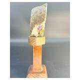 A mesmerizing deep amethyst portal, showcasing rich violet crystals that form a natural, glowing window into the stone’s heart. On a custom wooden stand.