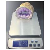 A mesmerizing deep amethyst portal, showcasing rich violet crystals that form a natural, glowing window into the stone’s heart. On a custom wooden stand.