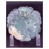 A hand-carved flower crafted from natural moss agate, showcasing intricate petal details and the stone’s unique green and earthy inclusions.