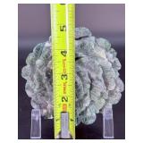 A hand-carved flower crafted from natural moss agate, showcasing intricate petal details and the stone’s unique green and earthy inclusions.