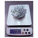 A hand-carved flower crafted from natural moss agate, showcasing intricate petal details and the stone’s unique green and earthy inclusions.