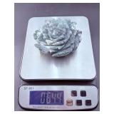 A hand-carved flower crafted from natural moss agate, showcasing intricate petal details and the stone’s unique green and earthy inclusions.