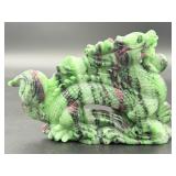A striking hand-carved dragon sculpted from natural ruby zoisite, showcasing vibrant green and deep red tones.
