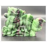 A striking hand-carved dragon sculpted from natural ruby zoisite, showcasing vibrant green and deep red tones.