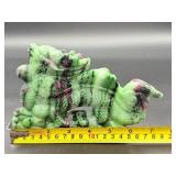 A striking hand-carved dragon sculpted from natural ruby zoisite, showcasing vibrant green and deep red tones.