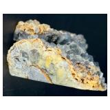 A striking specimen of large blue fluorite perched atop a clear quartz crystal matrix.