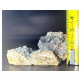 A striking specimen of large blue fluorite perched atop a clear quartz crystal matrix.