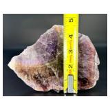 A vibrant Super 7 slice showcasing the unique combination of seven powerful minerals—amethyst, cacoxenite, goethite, lepidocrocite, rutile, smoky quartz, and clear quartz.